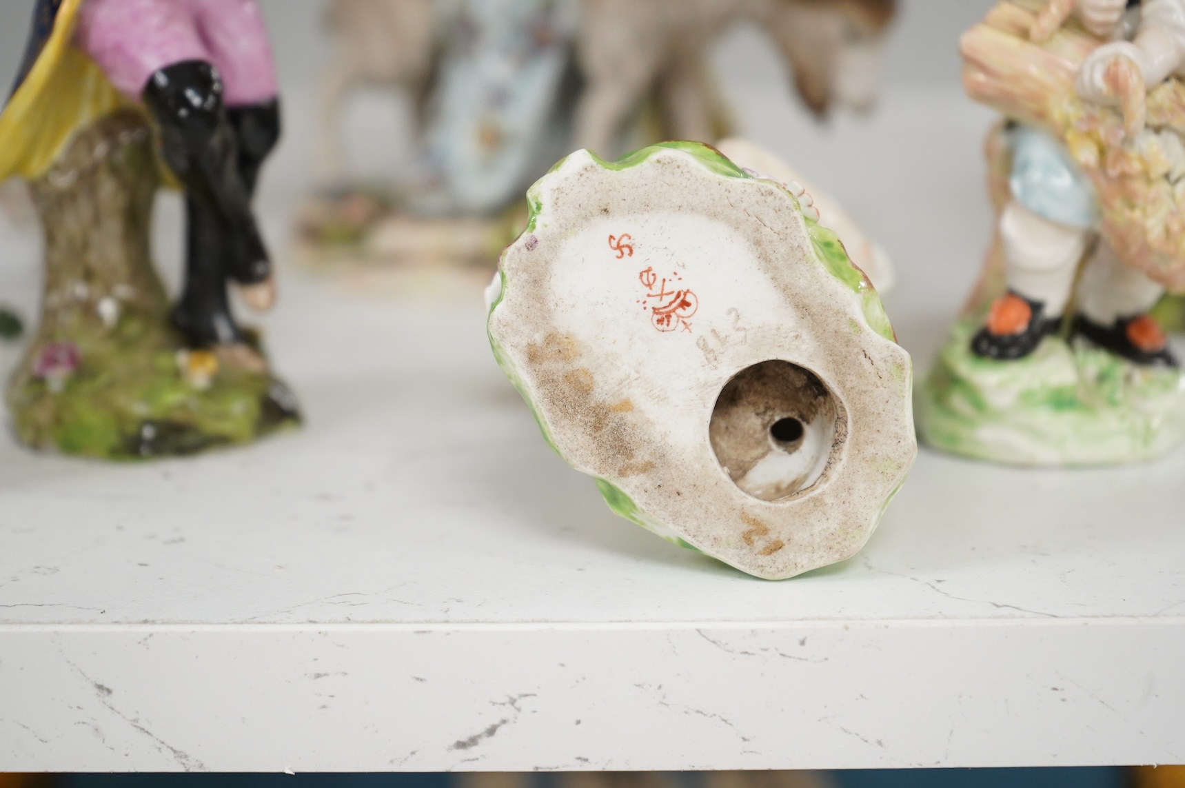Two Derby porcelain seated figures emblematic of summer and autumn and a collection of Continental porcelain figures to include a pair of recumbent cows, largest 18cm high
